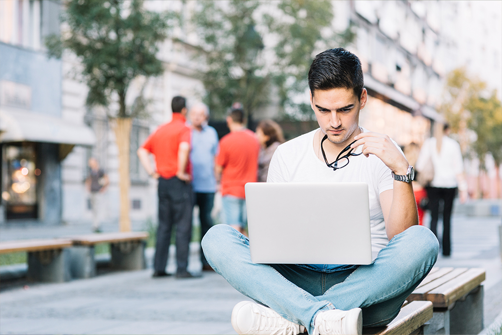 A Collage student watching on laptop